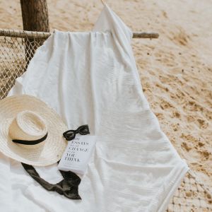 ribbon book sunglasses and hat on hammock